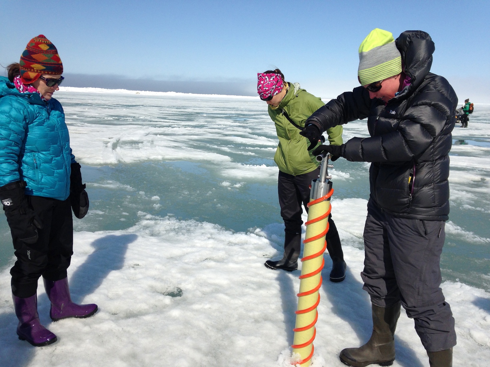 The Red Team drilling an ice core of sea ice.