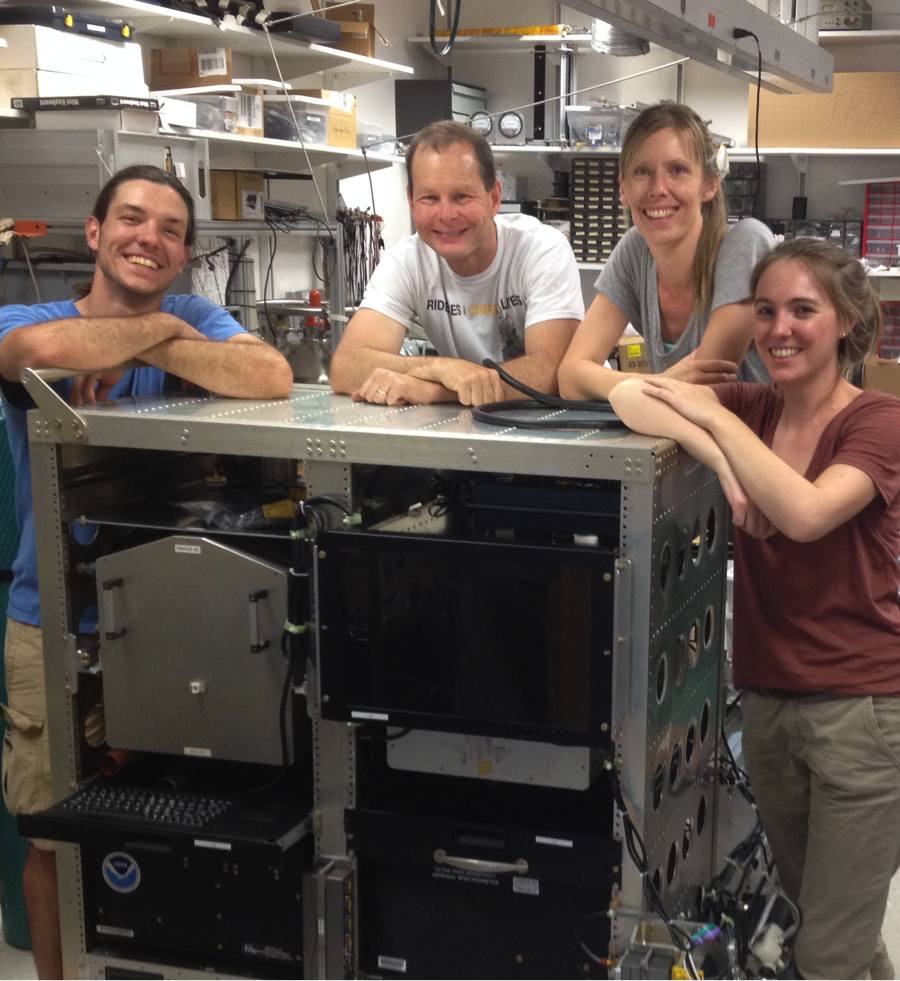My research team in our lab at NOAA ESRL setting up our flight rack for ATom. From left to right, Frank Erdesz, engineer with CIRES/NOAA, Charles Brock, Principal Investigator from NOAA, Agneiszka Kupc, research scientist with NOAA/University of Vienna, and Christina Williamson, research scientist with CIRES/NOAA. (Credit: Nick Wagner)