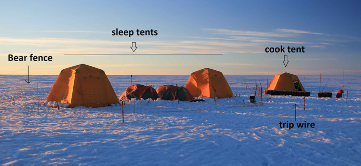 Anatoly is laying on a tarp finishing connecting the wires to the instruments. The bamboo stick marks one corner of the loop.