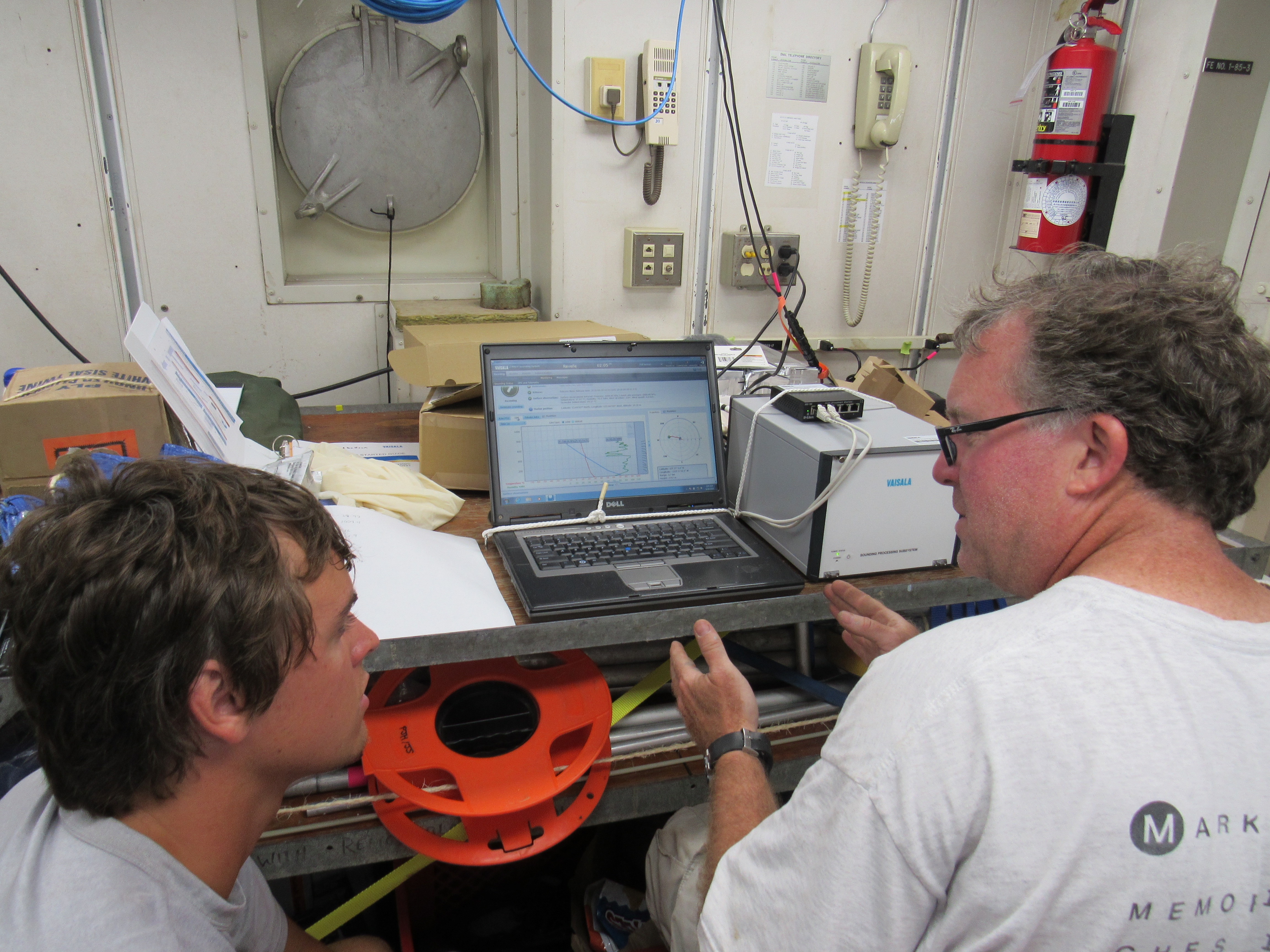 Jim Edson from University of Connecticut and Raymond Graham, a graduate student at U.Conn., looking over the first results from the balloon deployment.