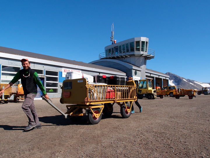 Clem and Olivia using airport baggage carts to move our boxes filled with equipment.