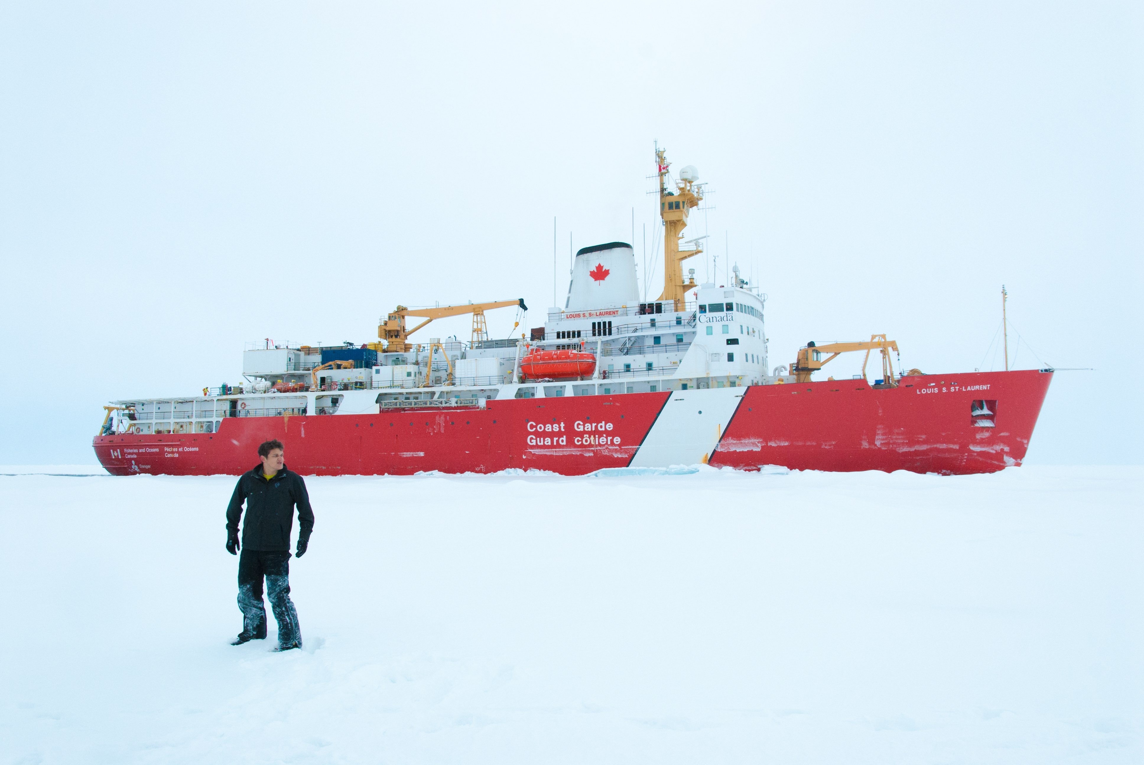 Your blogger, Alek Petty, out on the ice during the 2014 Joint Ocean Ice Study research expedition, with the Louis S. St. Laurent in the background.