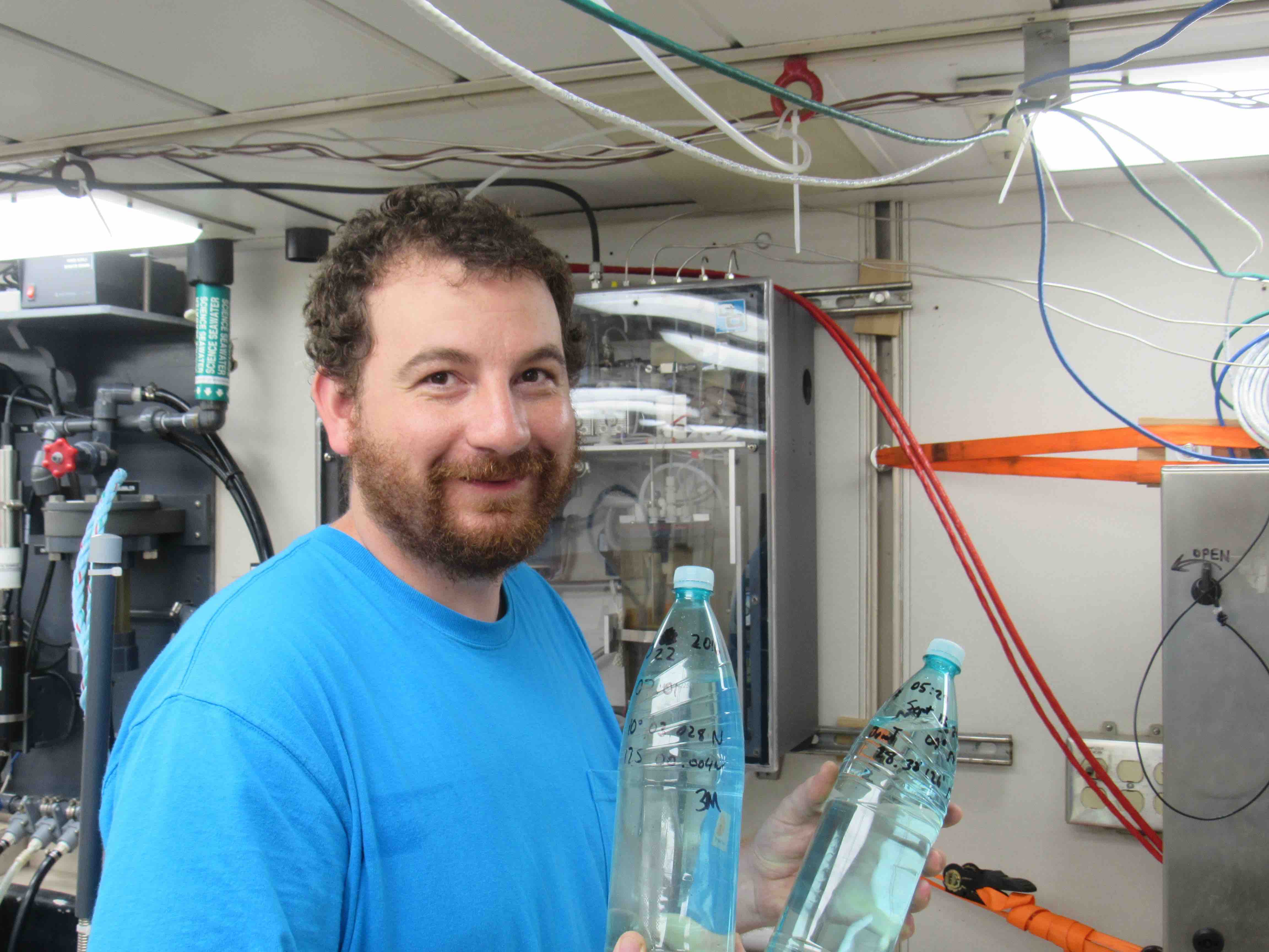 Dan Clark with two of his nearly 50 bottles of samples for investigation of ocean microplastics.