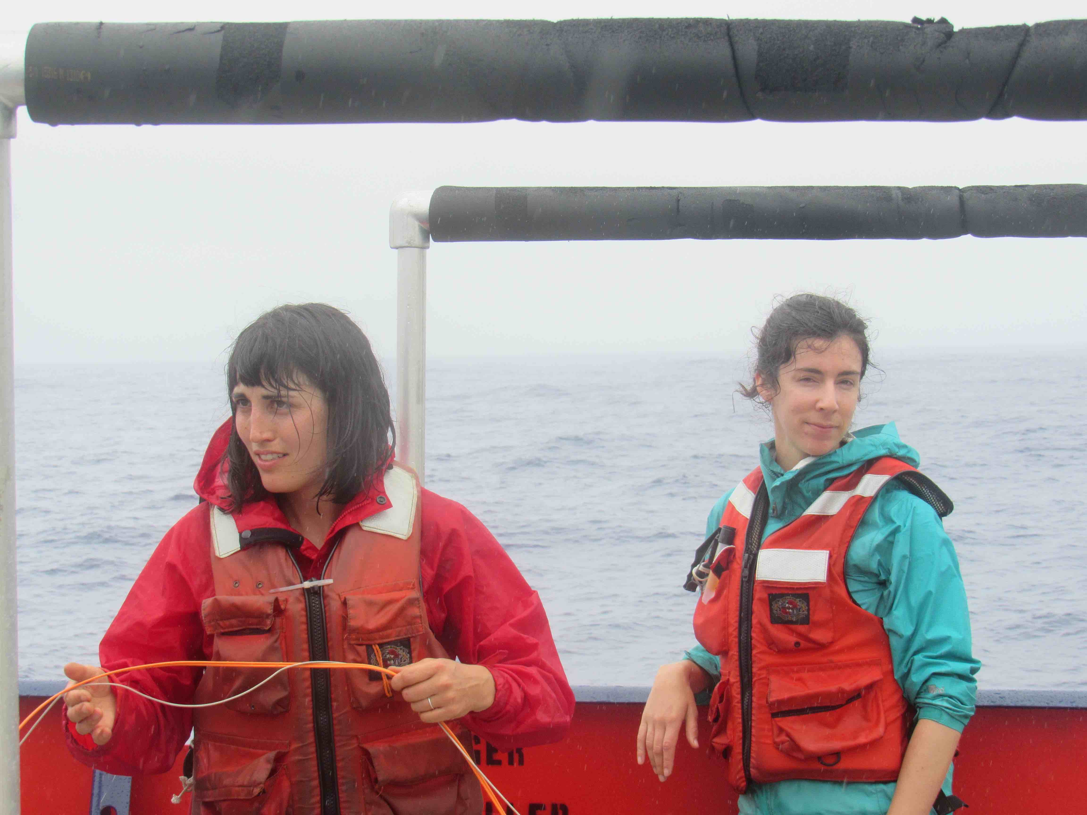 Kyla Drushka and Caitlin Whalen from APL, hard at work in the rain.