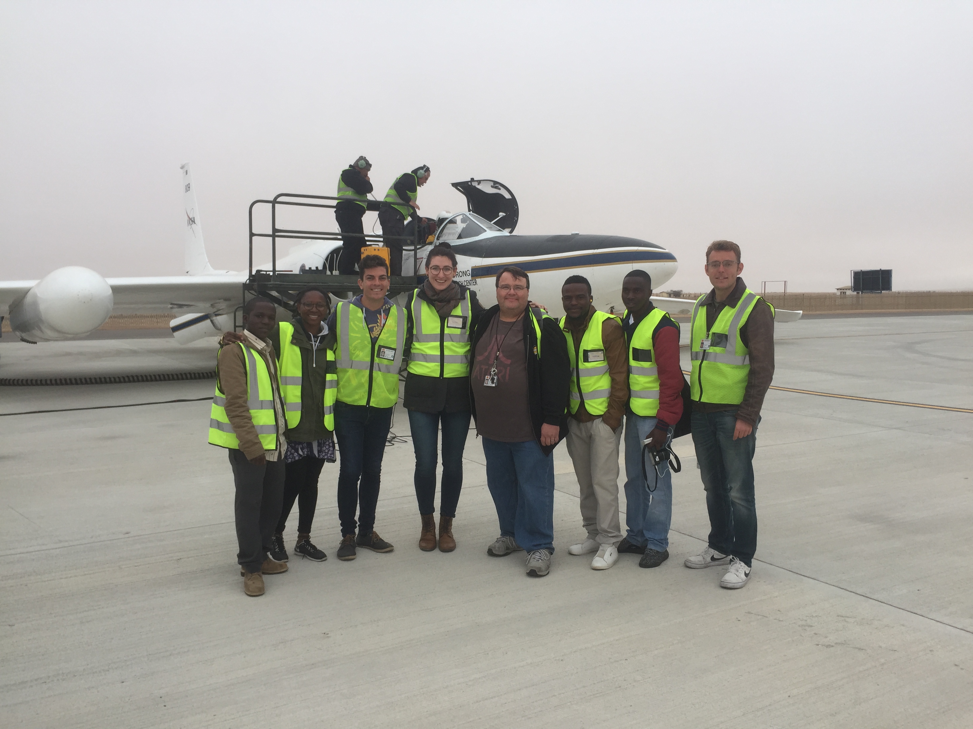 Namibian interns in front of the ER-2 aircraft, checking out our instrument: “AirMSPI”. Credit: Walvis Bay airport employees.