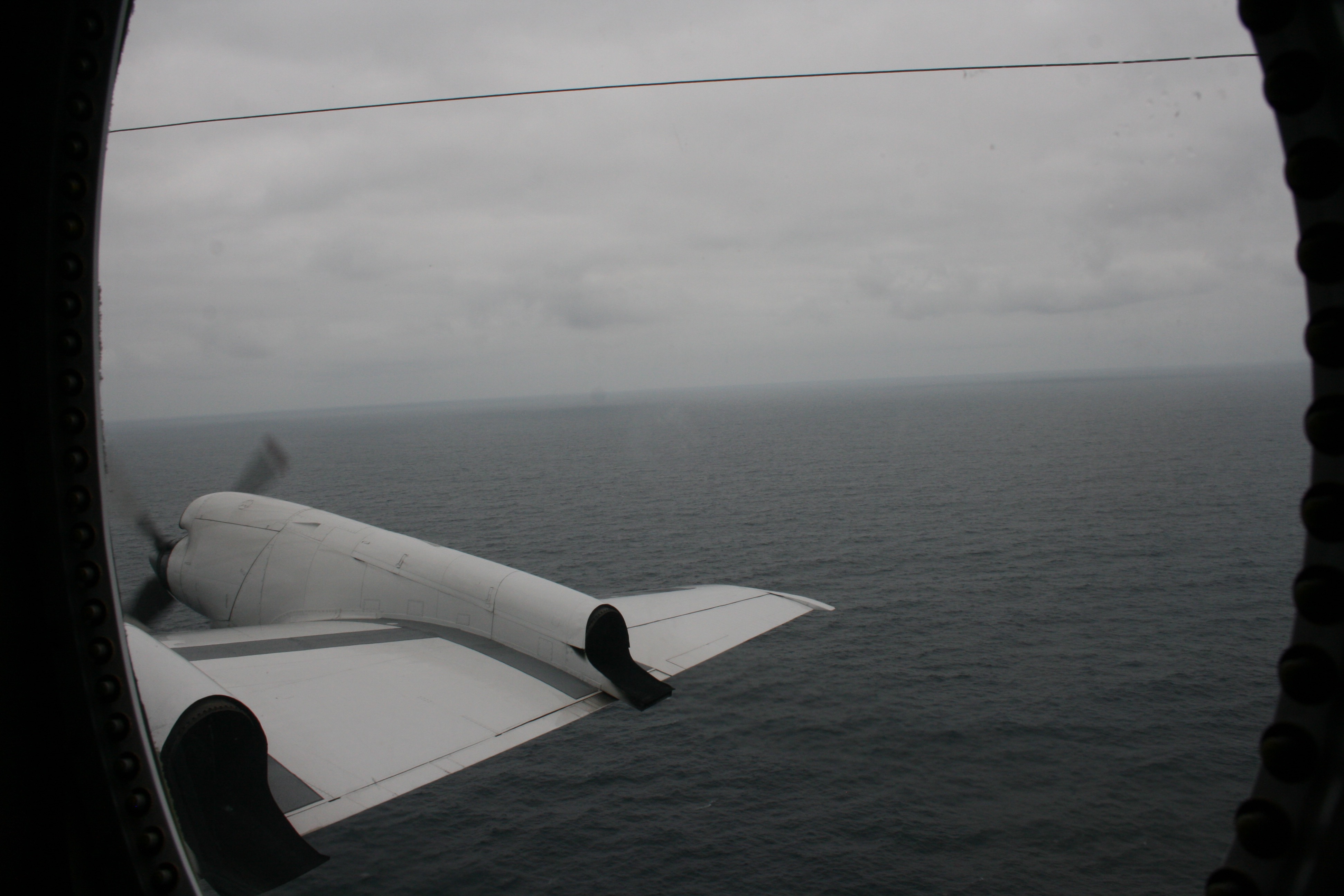 View of the marine boundary layer with stratocumulus clouds above and the Atlantic Ocean below from outside the P3 window. Photo credit: Michael Diamond