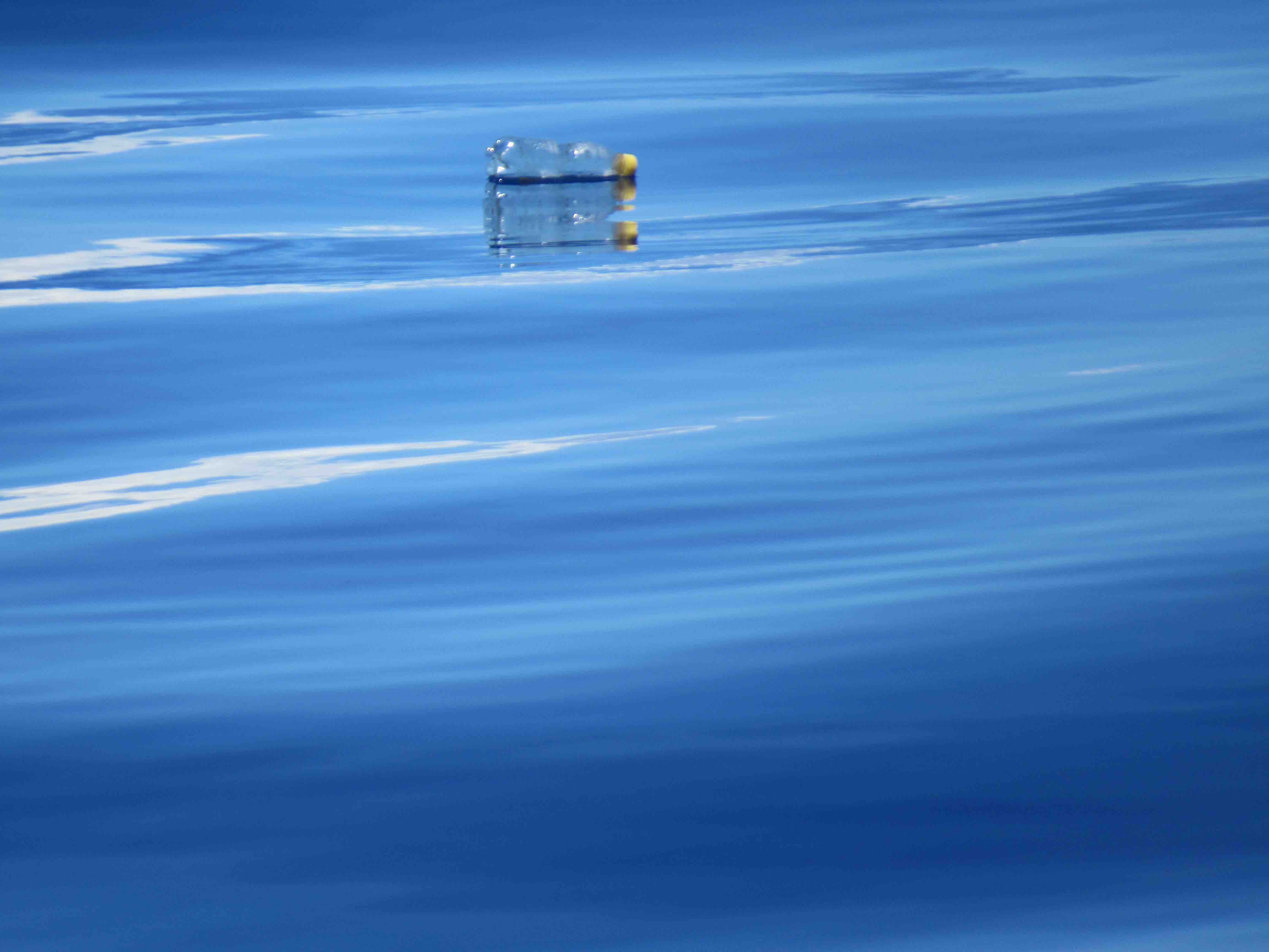 Plastic bottle floating by the ship.
