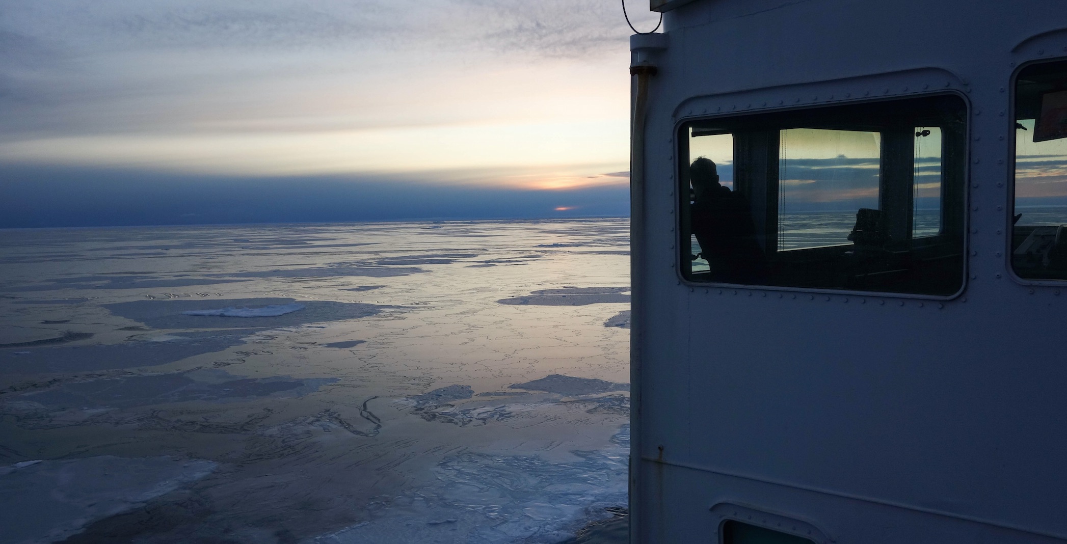 Scientist Adam Monier looks out over Arctic sea ice.