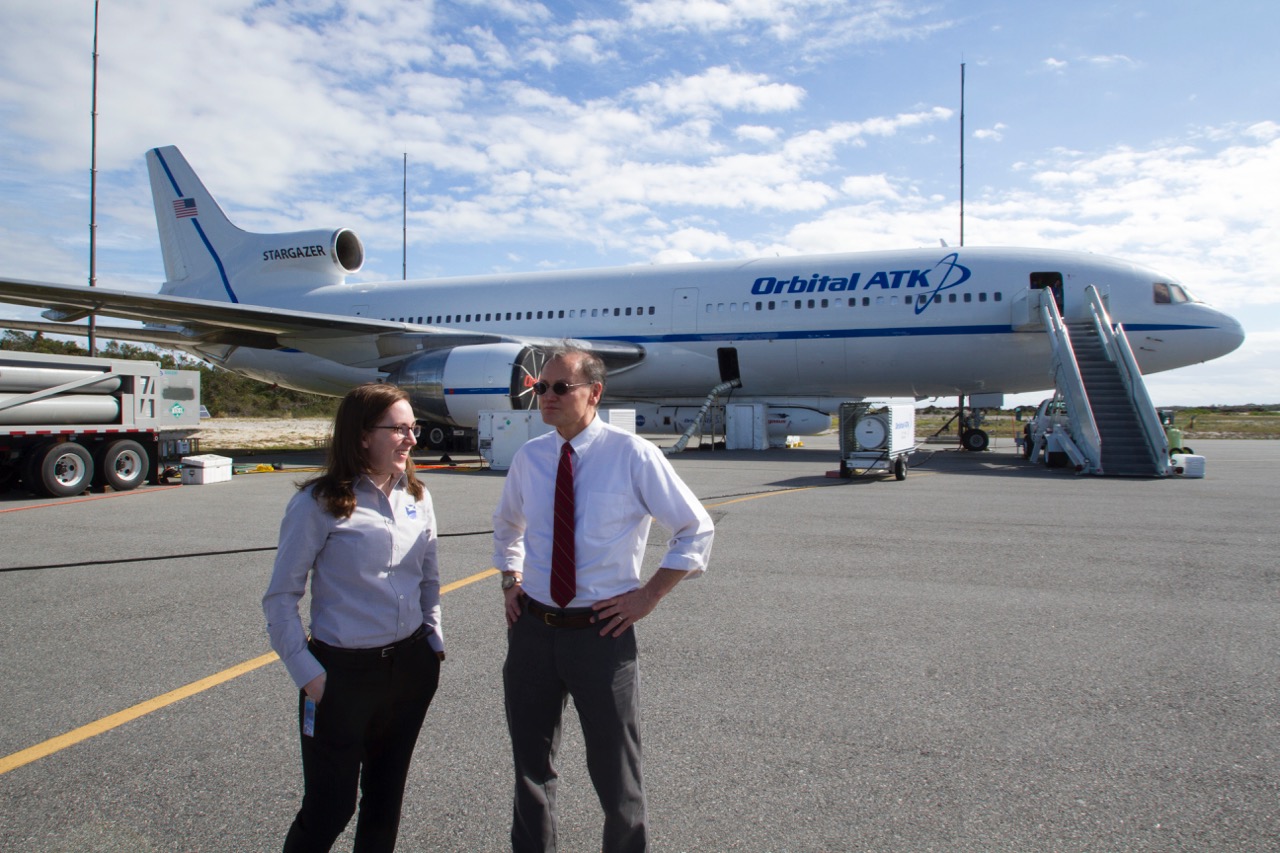 Prof. Ruf and I chat with the L-1011 aircraft and Pegasus XL rocket in the background. Photo credit: Aaron Ridley