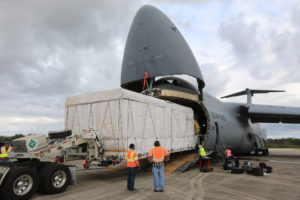NOAA's GOES-S is offloaded from a C-5 transport aircraft onto the flatbed of a heavy-lift truck at the Shuttle Landing Facility at NASA's Kennedy Space Center in Florida.