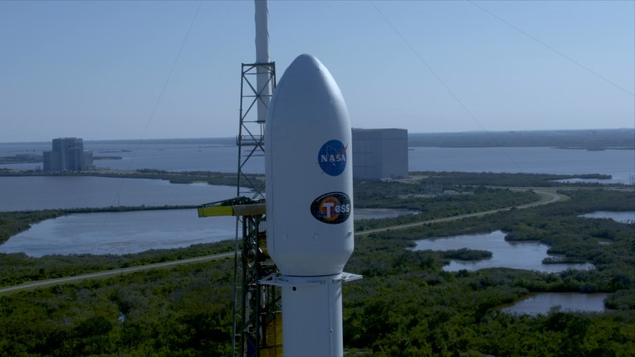 The payload fairing atop the SpaceX Falcon 9 rocket contains NASA's TESS spacecraft. The rocket is poised for liftoff at Space Launch Complex 40 on Cape Canaveral Air Force Station.