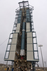 The United Launch Alliance Delta II first stage is lifted up in the mobile service tower.