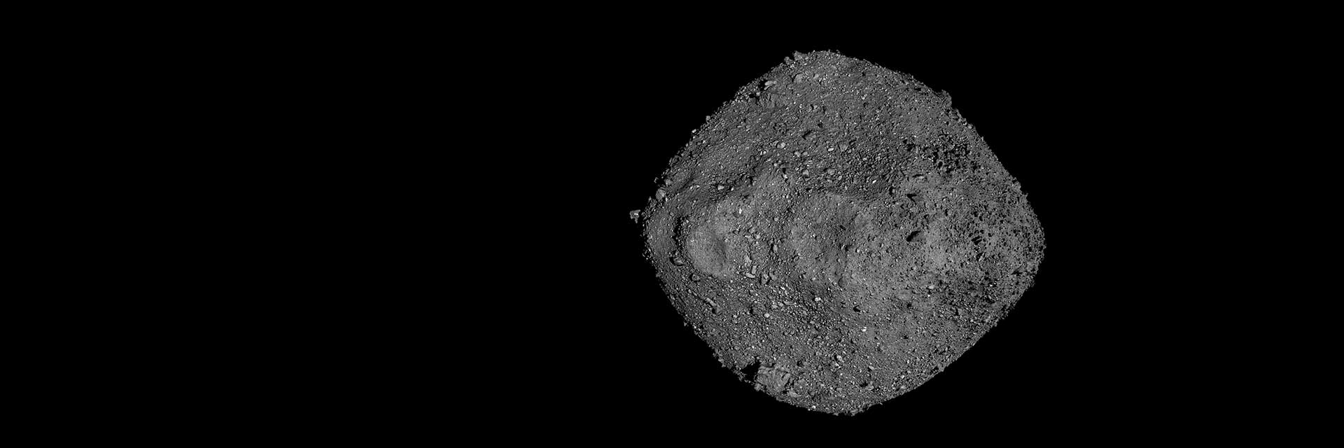 Closeup view of a rocky, diamond-shaped asteroid in space
