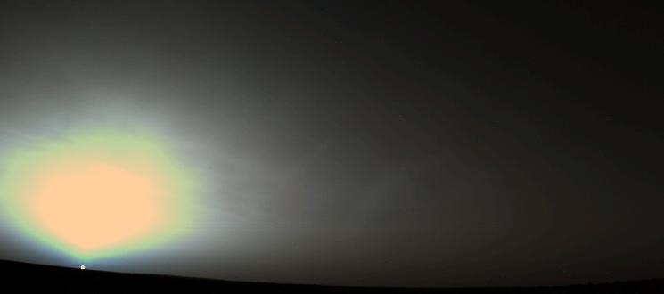 Bright orange Sun rises in a dark sky on Mars