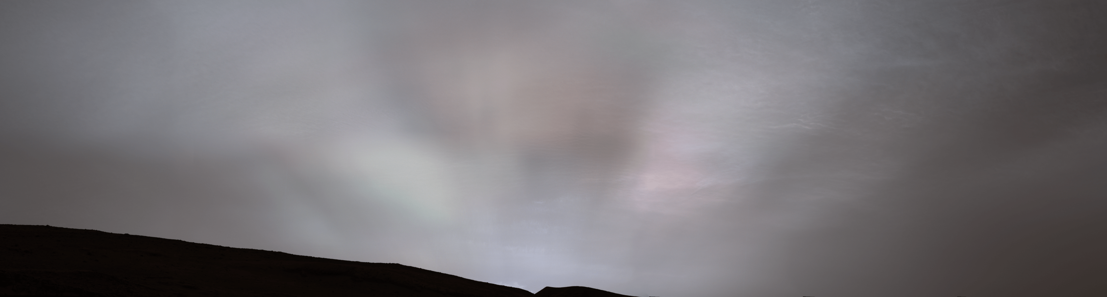 Colorful rays are seen as the Sun sets on Mars