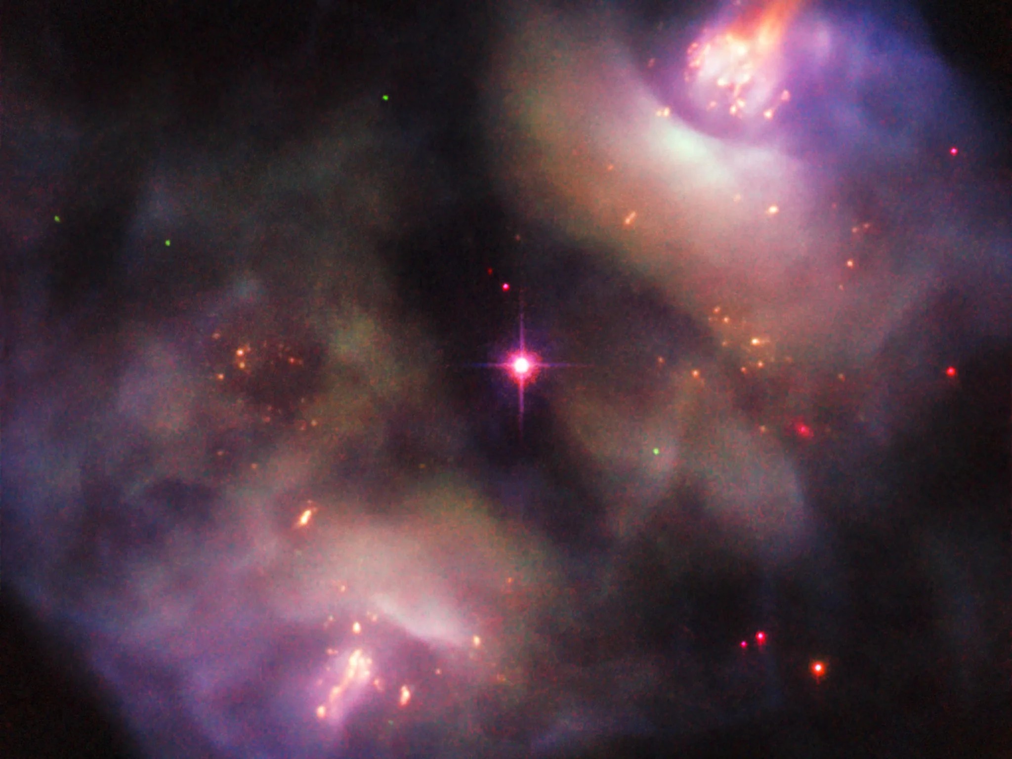 This atmospheric Picture of the Week, taken with the NASA/ESA Hubble Space Telescope, shows a dark, gloomy scene in the constellation of Gemini (The Twins). The subject of this image confused astronomers when it was first studied — rather than being classified as a single object, it was instead recorded as two objects, owing to its symmetrical lobed structure (known as NGC 2371 and NGC 2372, though sometimes referred to together as NGC 2371/2).  These two lobes are visible to the upper right and lower left of the frame, and together form something known as a planetary nebula. Despite the name, such nebulae have nothing to do with planets; NGC 2371/2 formed when a Sun-like star reached the end of its life and blasted off its outer layers, shedding the constituent material and pushing it out into space to leave just a superheated stellar remnant behind. This remnant is visible as the orange-tinted star at the centre of the frame, sitting neatly between the two lobes. The structure of this region is complex. It is filled with dense knots of gas, fast-moving jets that appear to be changing direction over time, and expanding clouds of material streaming outwards on diametrically opposite sides of the remnant star. Patches of this scene glow brightly as the remnant star emits energetic radiation that excites the gas within these regions, causing it to light up. This scene will continue to change over the next few thousand years; eventually the knotty lobes will dissipate completely, and the remnant star will cool and dim to form a white dwarf.  Links: Image of NGC 2371 published in 2008 Image of NGC 2371 published 1997