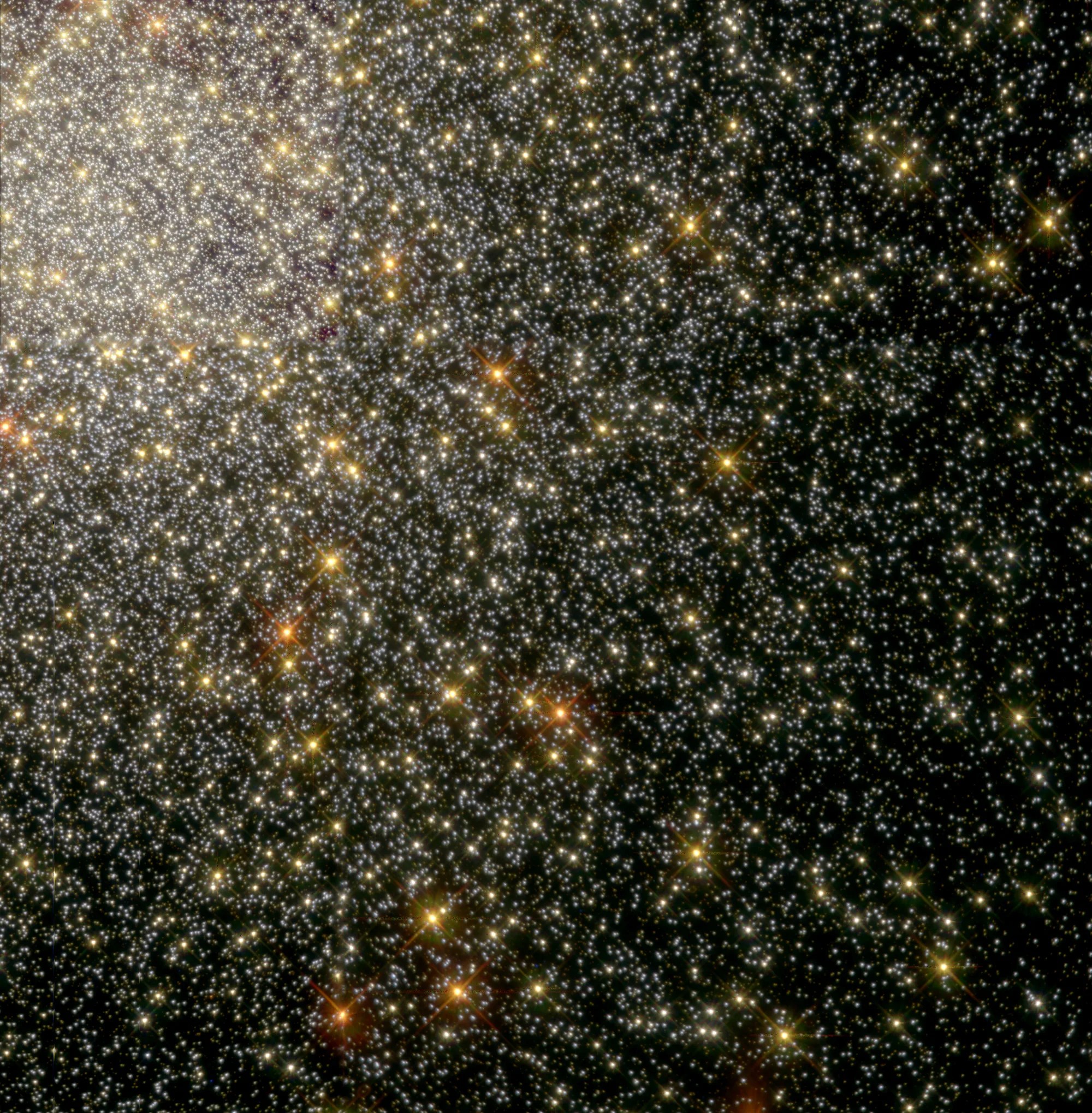 A mass of yellow and white stars fill the upper-left corner and taper off toward the lower-right corner. Reddish-orange stars dot the scene, all on a black background.