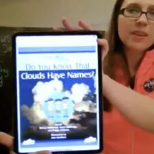 Girl showing Clouds have Names on iPad