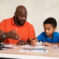 Man help child with science paperwork