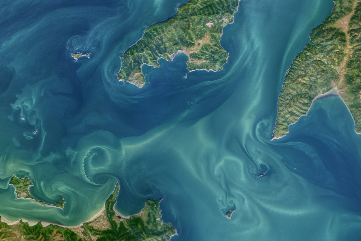 Strong tides create laminar and turbulent flow patterns in waters off far eastern Russia.