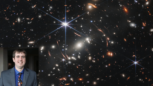 Photo of webinar guest, Dr. Patrick Breysse, in the bottom-left corner/foreground. Behind this photo: a deep field image captured by the NASA James Webb Space Telescope of the SMACS 0723 galaxy cluster; distant galaxies appear as bright glowing spots, with some smeared by gravitational lensing; foreground stars appear bright with six-pointed diffraction spikes, owing to the shape of Webb's mirrors.