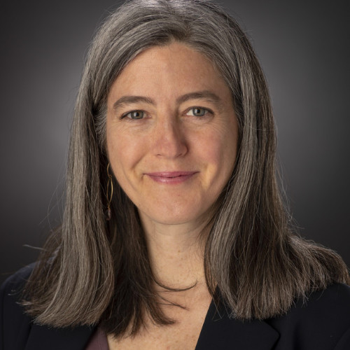 Portrait photo of a smiling woman with shoulder length dark hair.