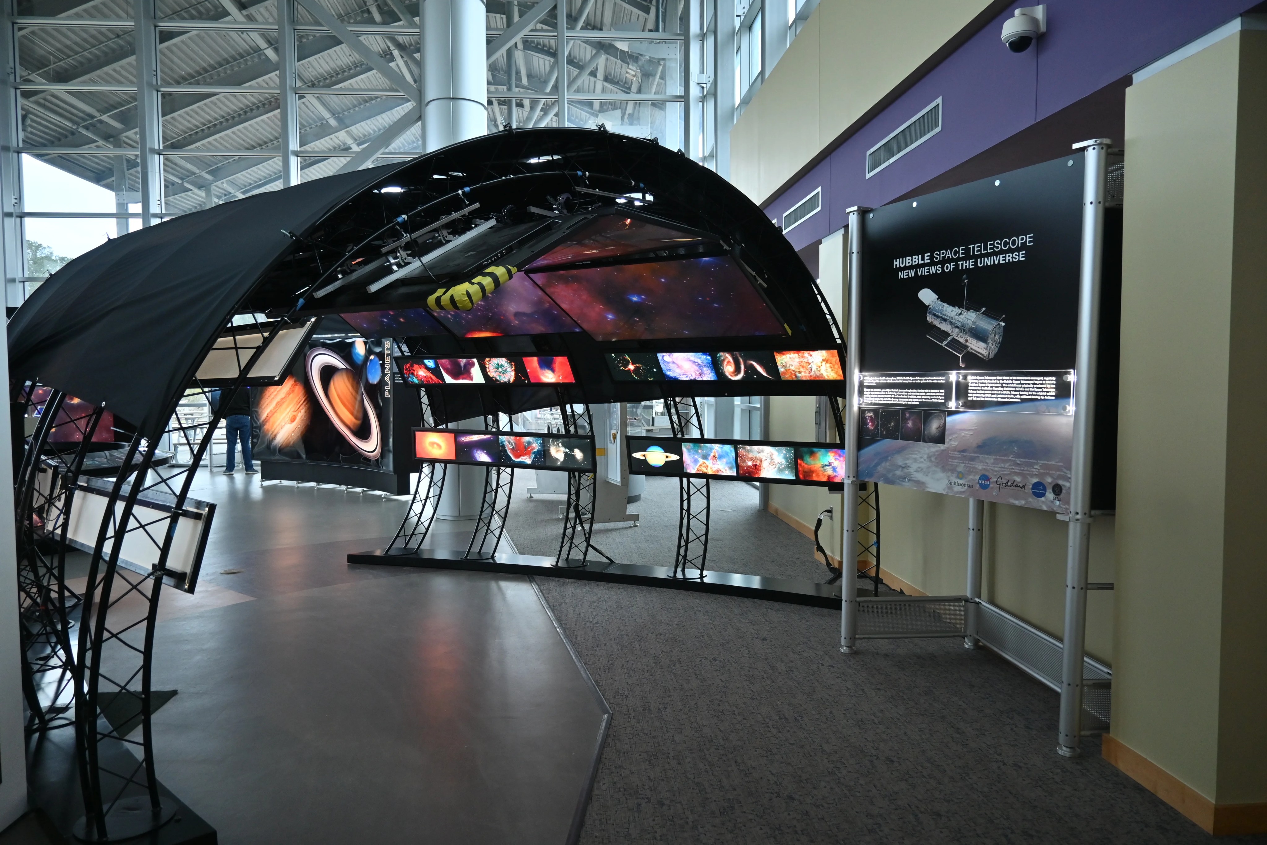 An interaction panel and tunne of Hubble images at the entryway of the Hubble traveling exhibit
