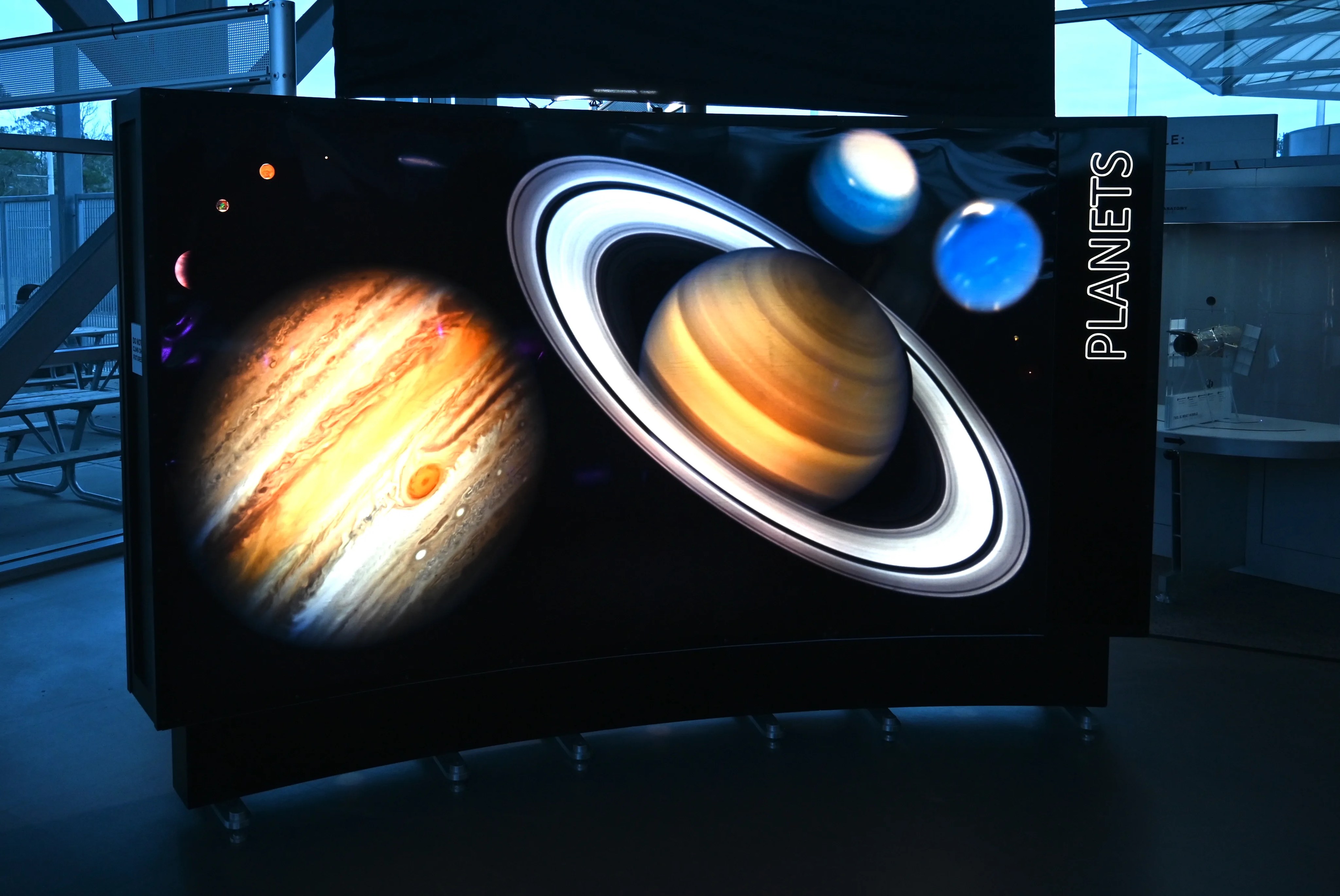 An 11 foot by 6 foot backlit image of a collage of planets