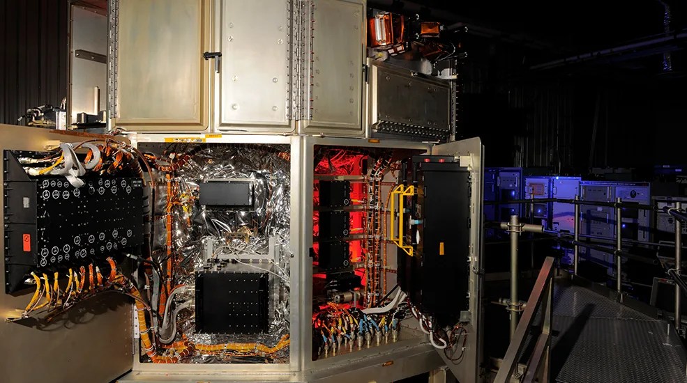 Image of the VEST (The Vehicle Electrical System Test facility) A Large silver piece of equipment with some of the doors open. Inside those doors are dozens of wires and engineering equipment.