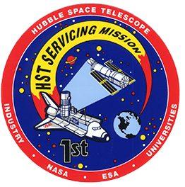 Hubble Servicing Mission One Mission Patch. Circular patch with a red border with the words "Hubble Space Telescope" on the top, and "Industry, NASA, ESA, Universities" at the bottom. The inner portion of the patch is blue with stars, and it shows the Shuttle swooping from the Earth, capturing Hubble, with big bold "HST Servicing Mission" written.