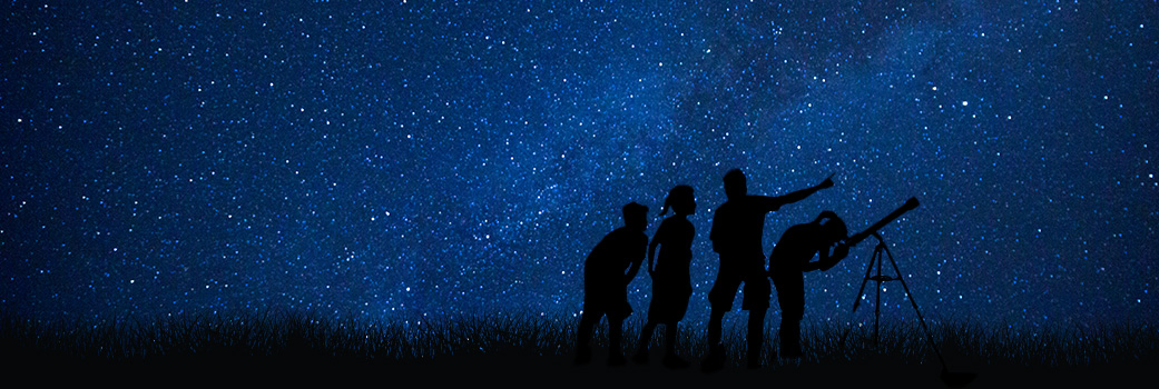 Dark blue starry night sky. People looking through a telescope and at the sky silhouetted against the starry backdrop.
