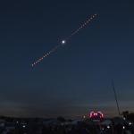 The progression of a total solar eclipse against a dark sky.