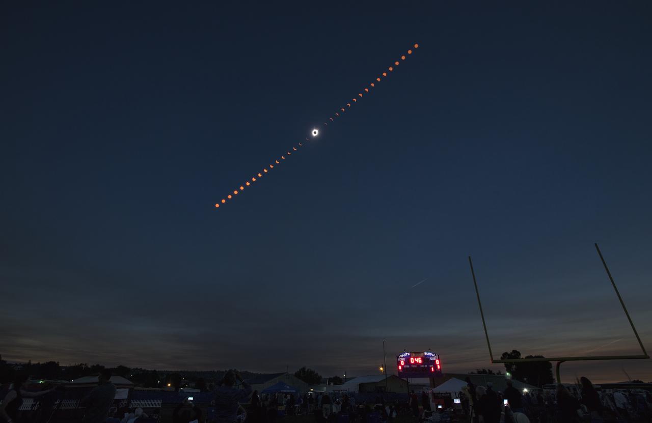 The progression of a total solar eclipse against a dark sky.