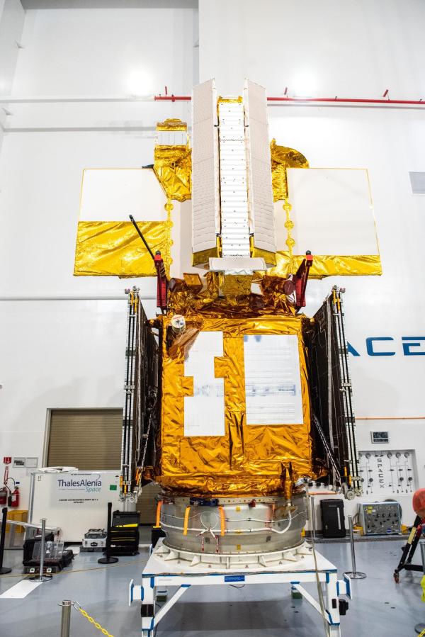 nside the SpaceX facility at Vandenberg Space Force Base in California, a crane is used to lower the Surface Water and Ocean Topography (SWOT) satellite for mating to the payload adapter on Dec. 5, 2022.