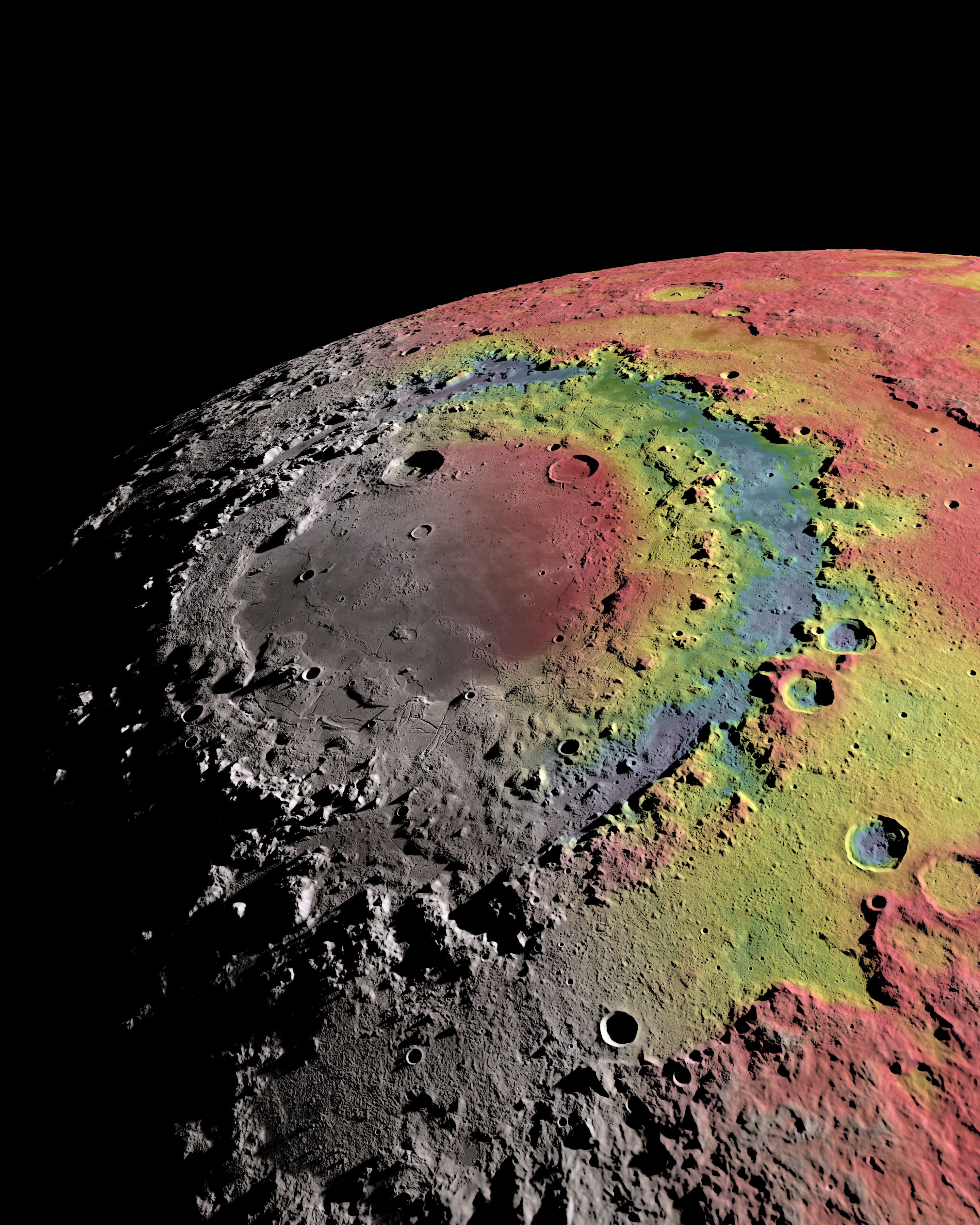 A photo of the Moon's Orientale impact basin. It is colored in to show free-air gravity differentiations. There are yellow areas (average gravity), green and blue areas (below average) and red areas (above average).
