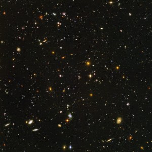 Field is filled with galaxies in colors of white, yellow, blue-white, and red; all on a black background.