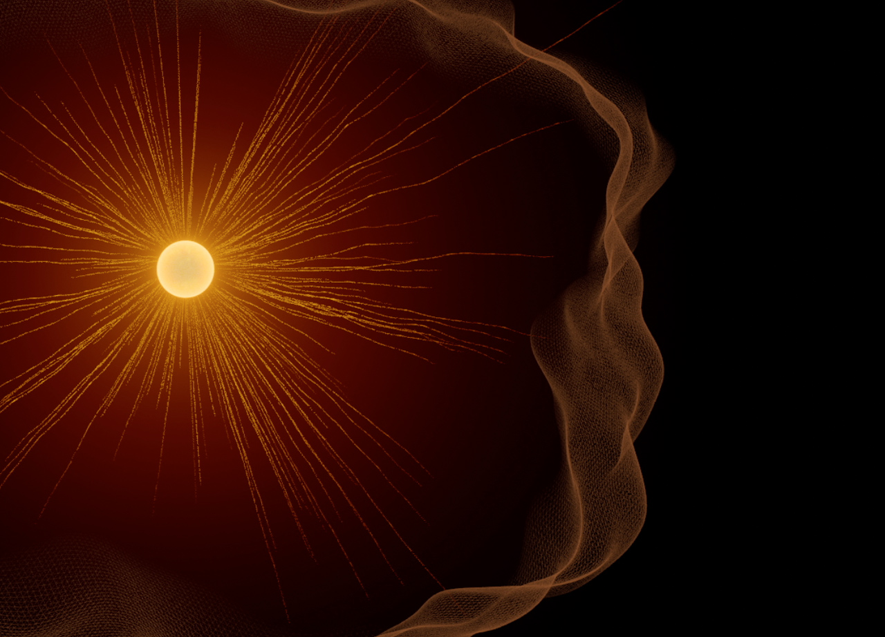 An artistic rendering of a small yellow Sun with orange rays emanating into black space. A wiggly translucent orange line surrounds the rays, representing the solar wind and heliosphere.