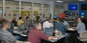 Engineers and astronauts go through a debriefing following a session in the Neutral Buoyancy Lab.