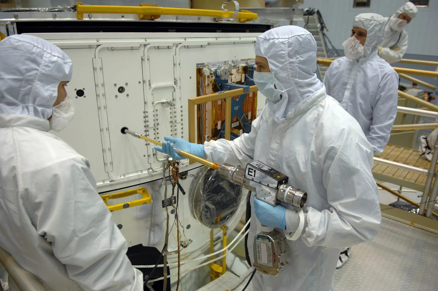 Photo of SM4 astronaut Drew Feustel training with the Pistol Grip Tool.