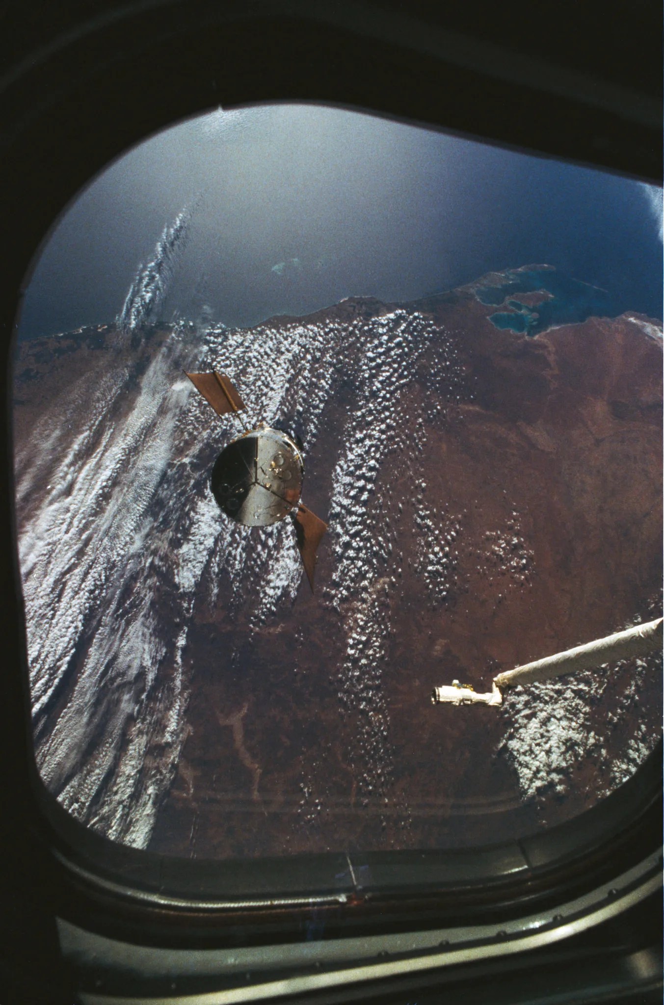 spacecraft over Earth seen through a window