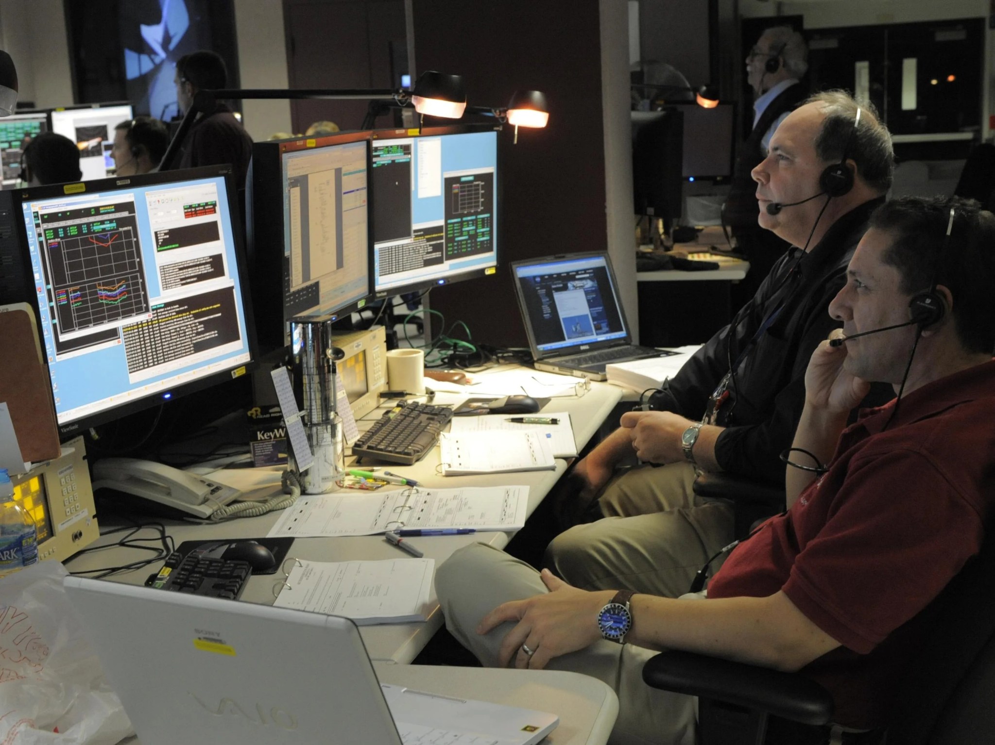 Technicians watch liftoff from the STOCC