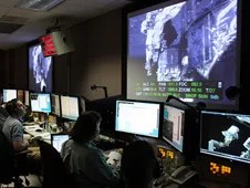 Personnel in the stocc watching the monitors during the fifth and final eva.