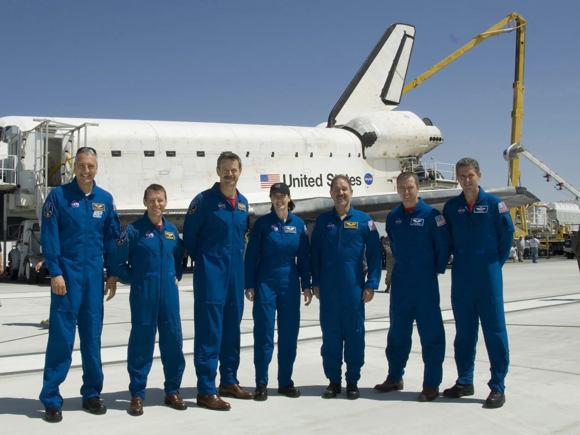 The crew of space shuttle mission sts-125 gathered on the runway after the shuttle atlantis landed.