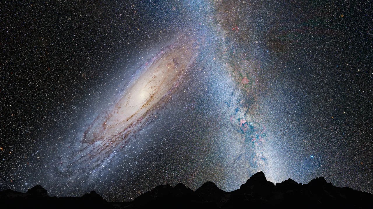 illustration of merging galaxies in night sky with rocky landscape silhouette in foreground