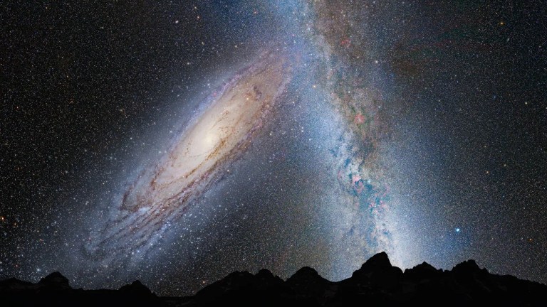 illustration of merging galaxies in night sky with rocky landscape silhouette in foreground