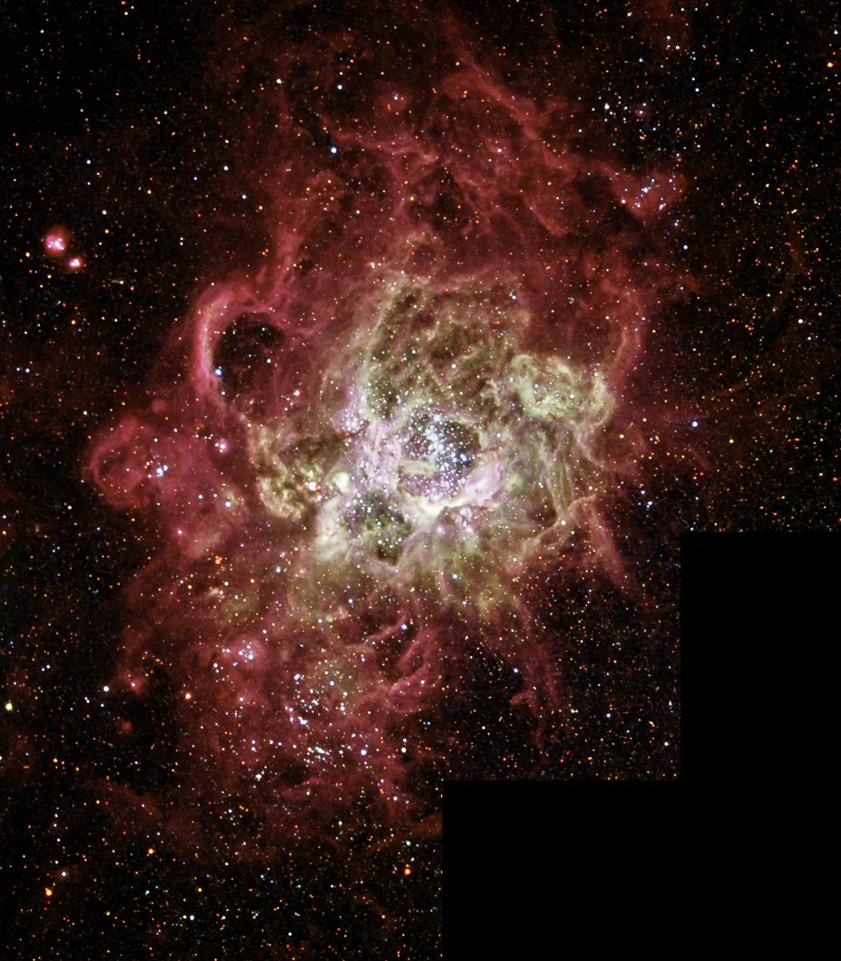 A star-forming nebula NGC 604 with red, white, and olive green gas and stars.
