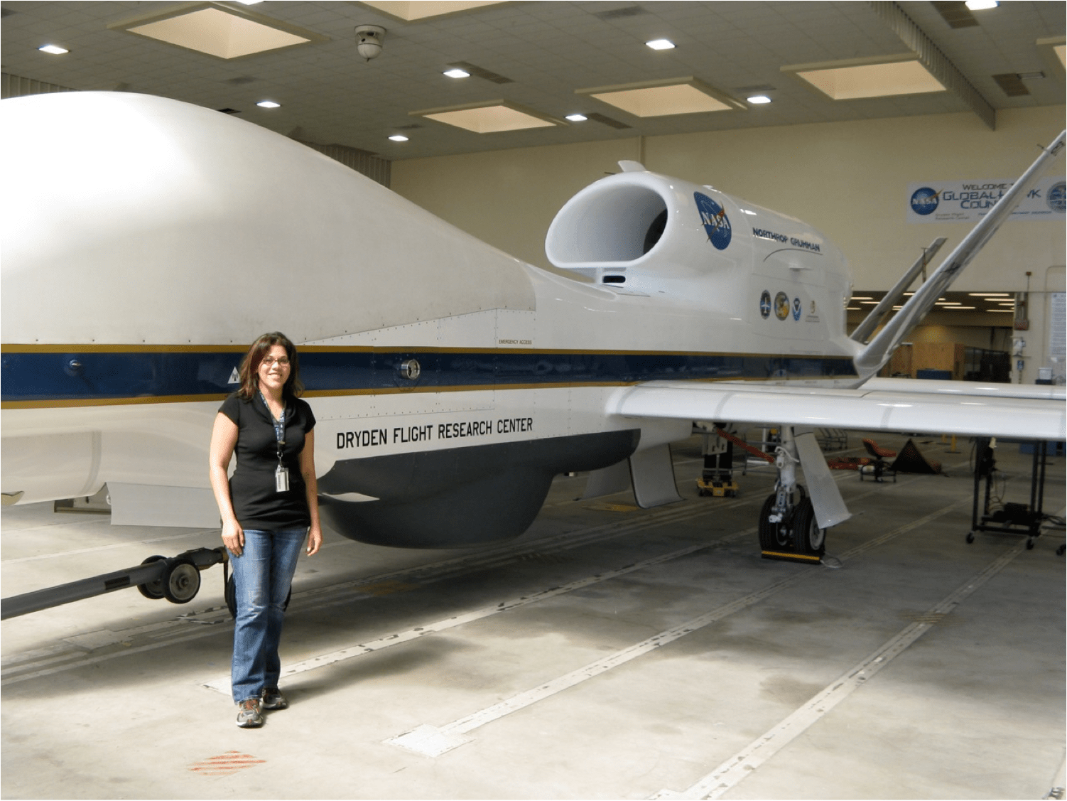 Amber standing in front of the Northrop Grumman RQ-4 Global Hawk unmanned aircraft.