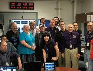 The current and alumni Cassini radio science team pose for a group photo.