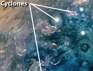 Three arrows pointing to cyclones on Jupiter
