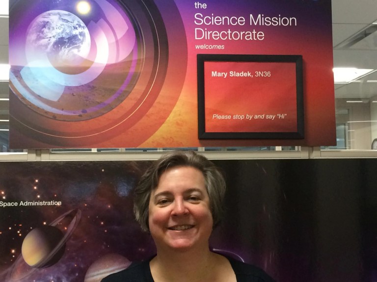 Mary F. Sladek in front of a poster board with her name and